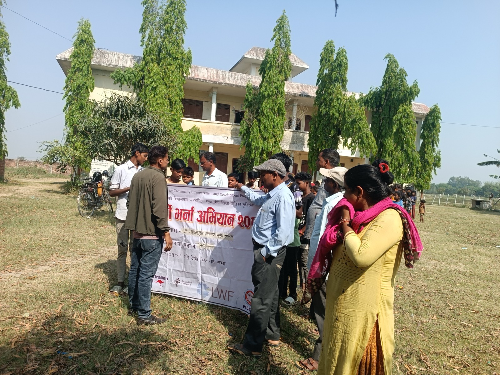 School enrolment campaign with community banner