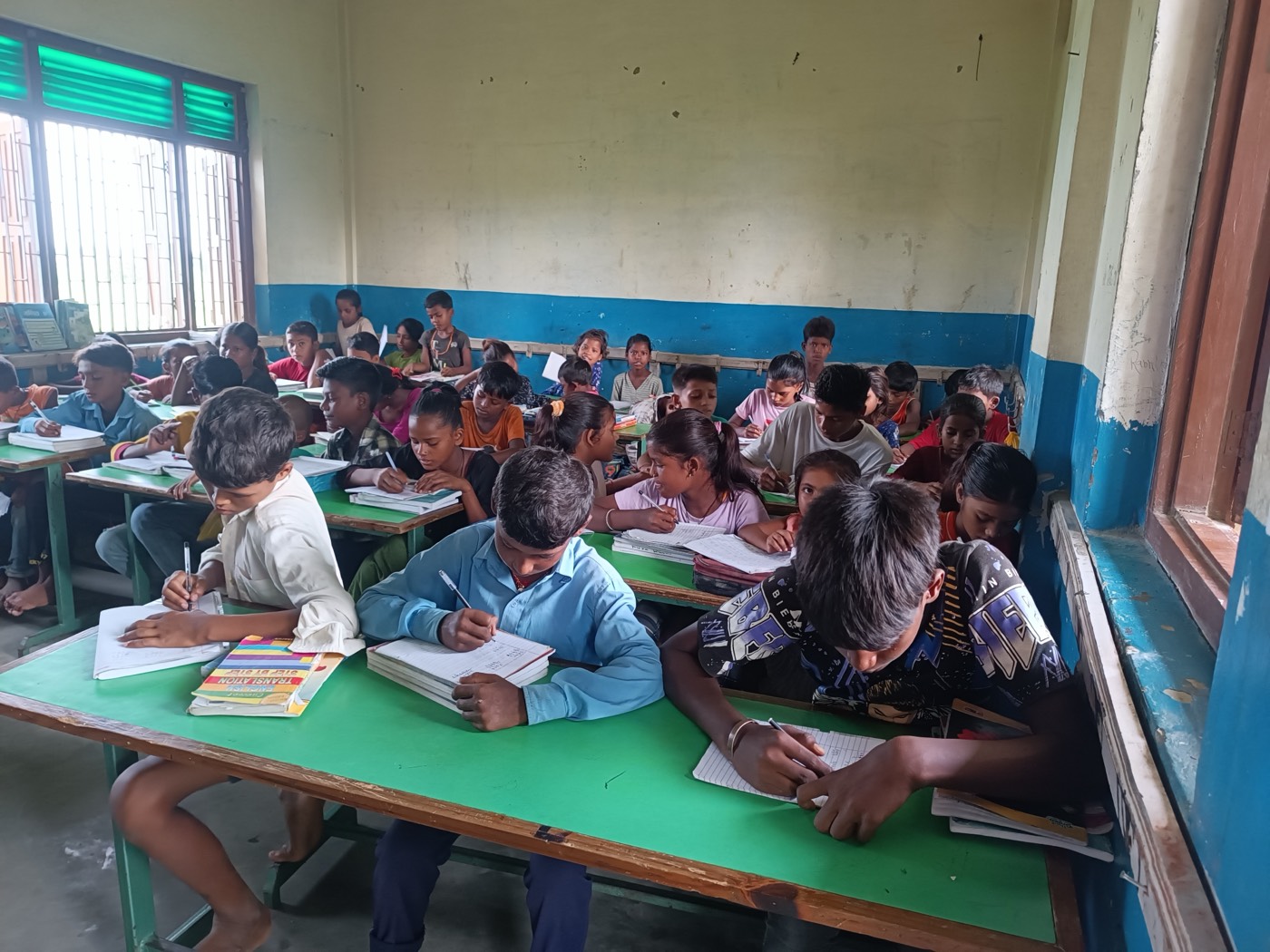 Primary grade students studying at their desks