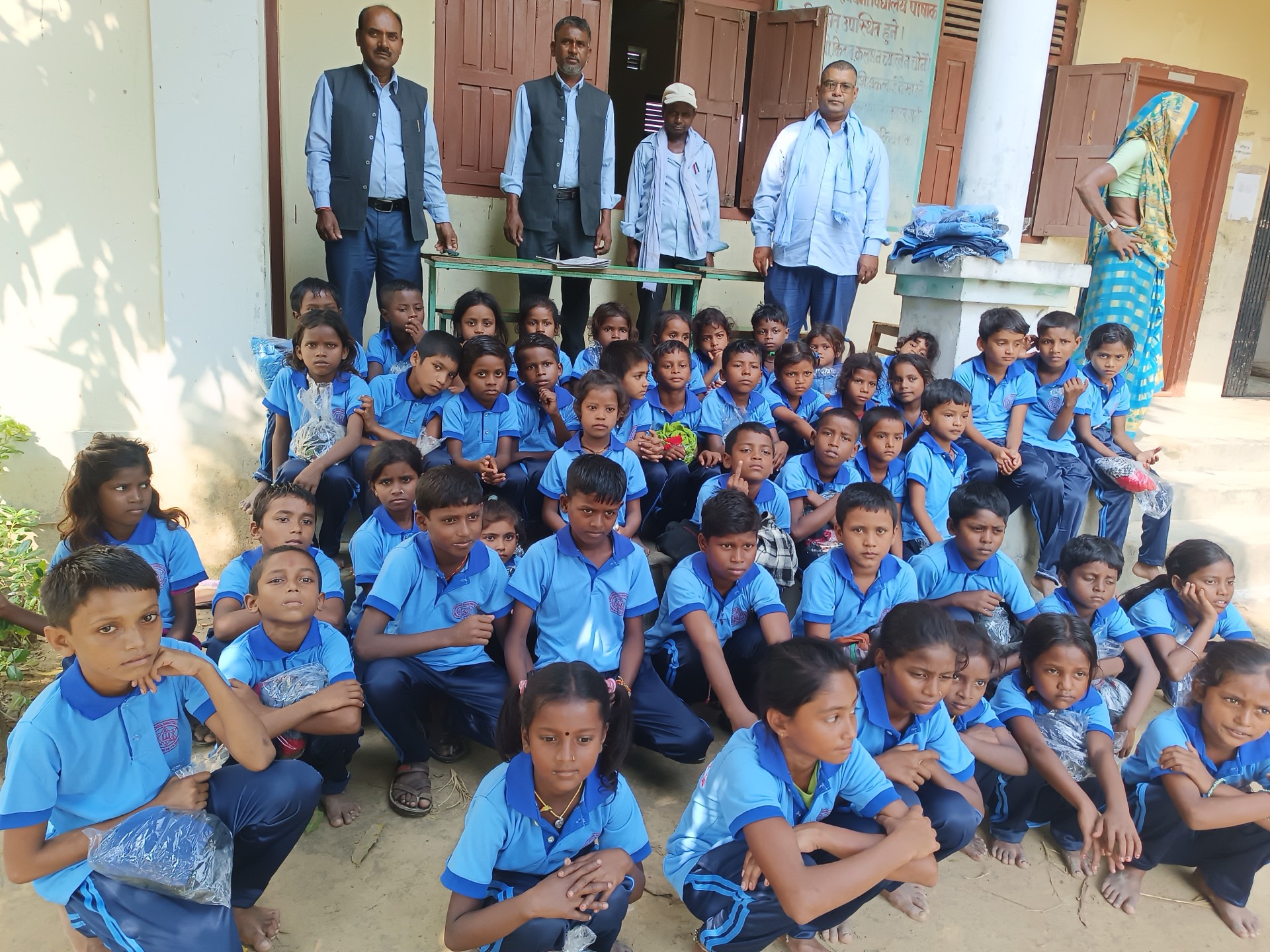 Students and teachers of Shree Basic School gathered outside the school building