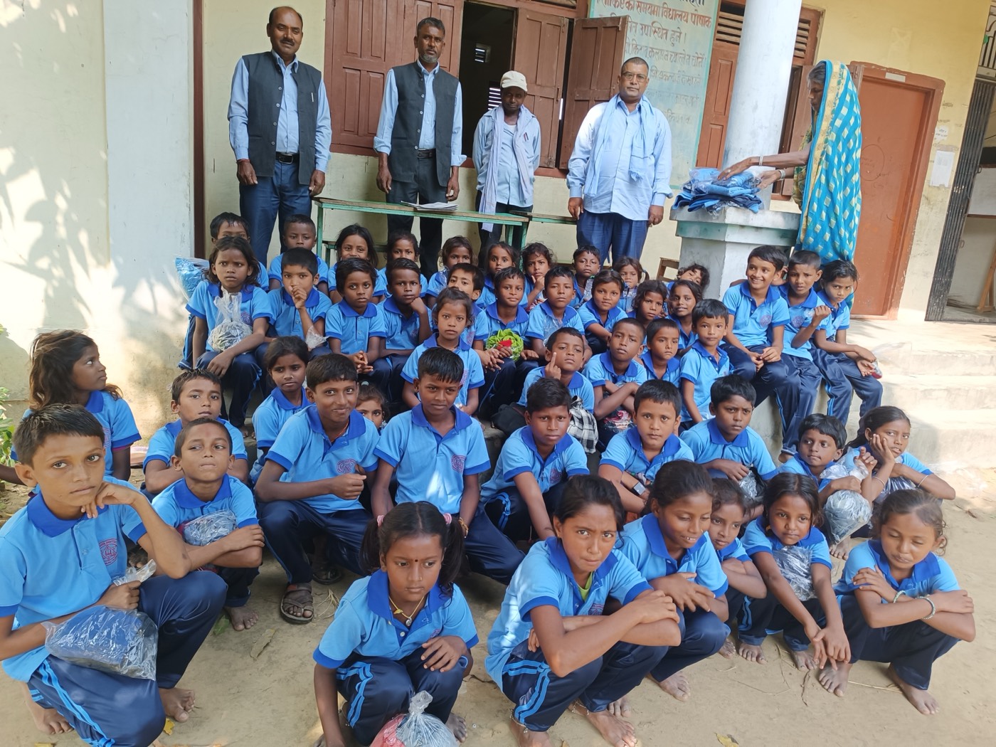 Students receiving school uniforms and supplies